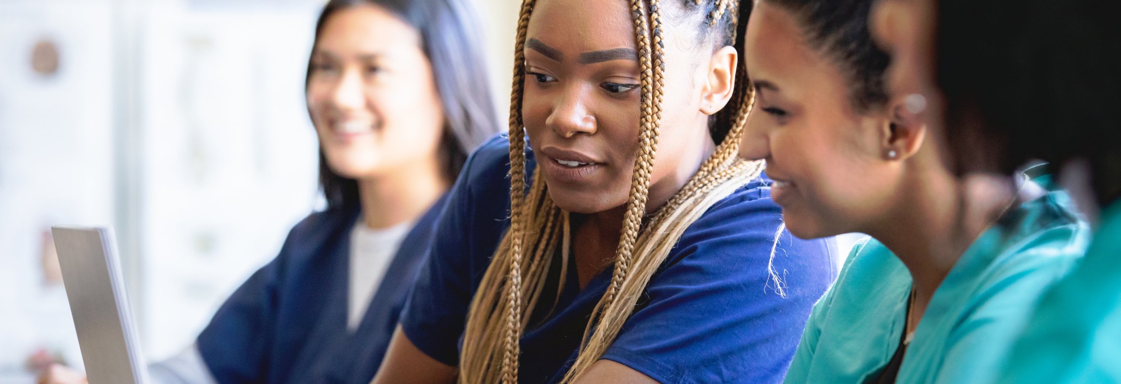 Diverse group of women who are nurses or medical students at local university